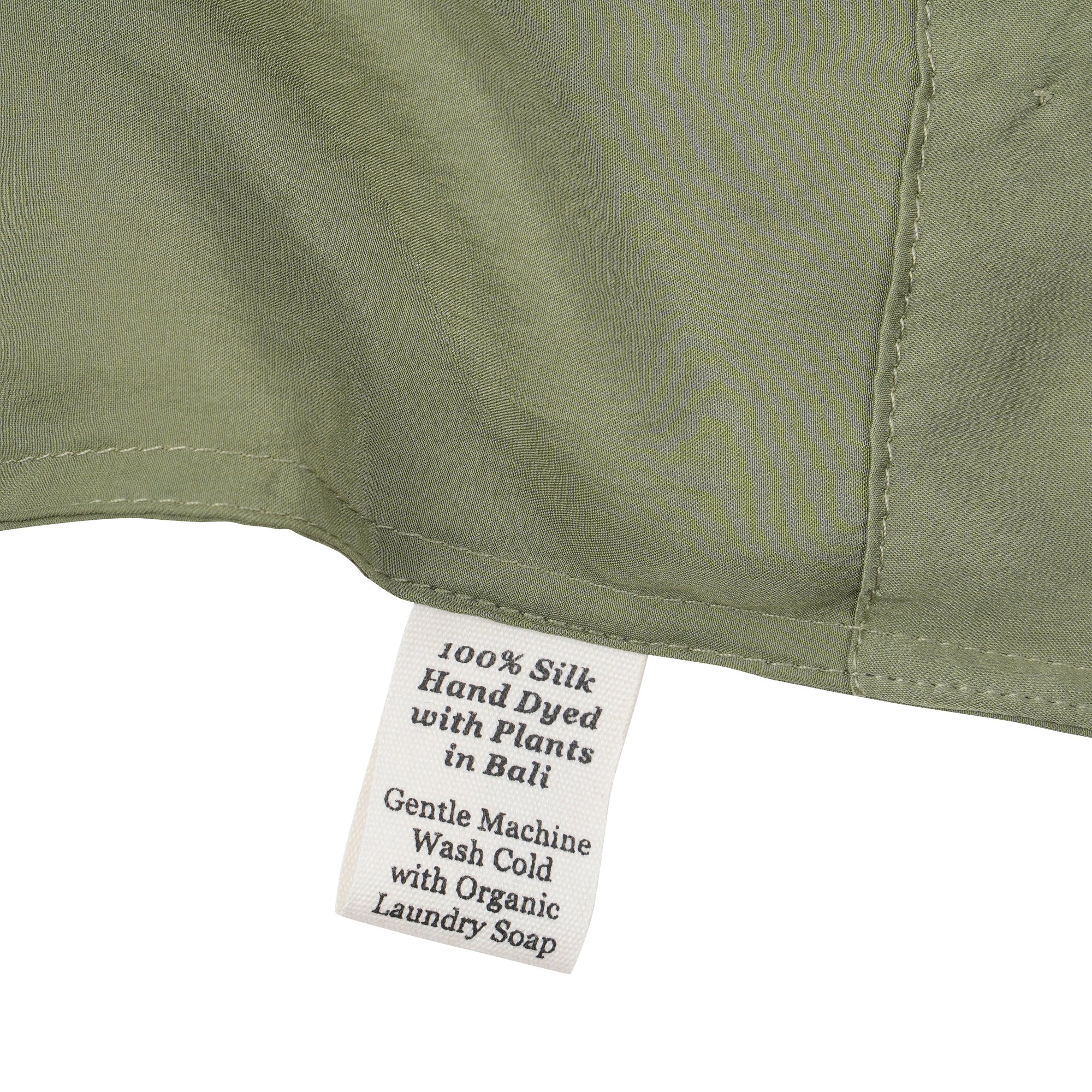 Close-up of a silk in Bark with a label detailing care instructions