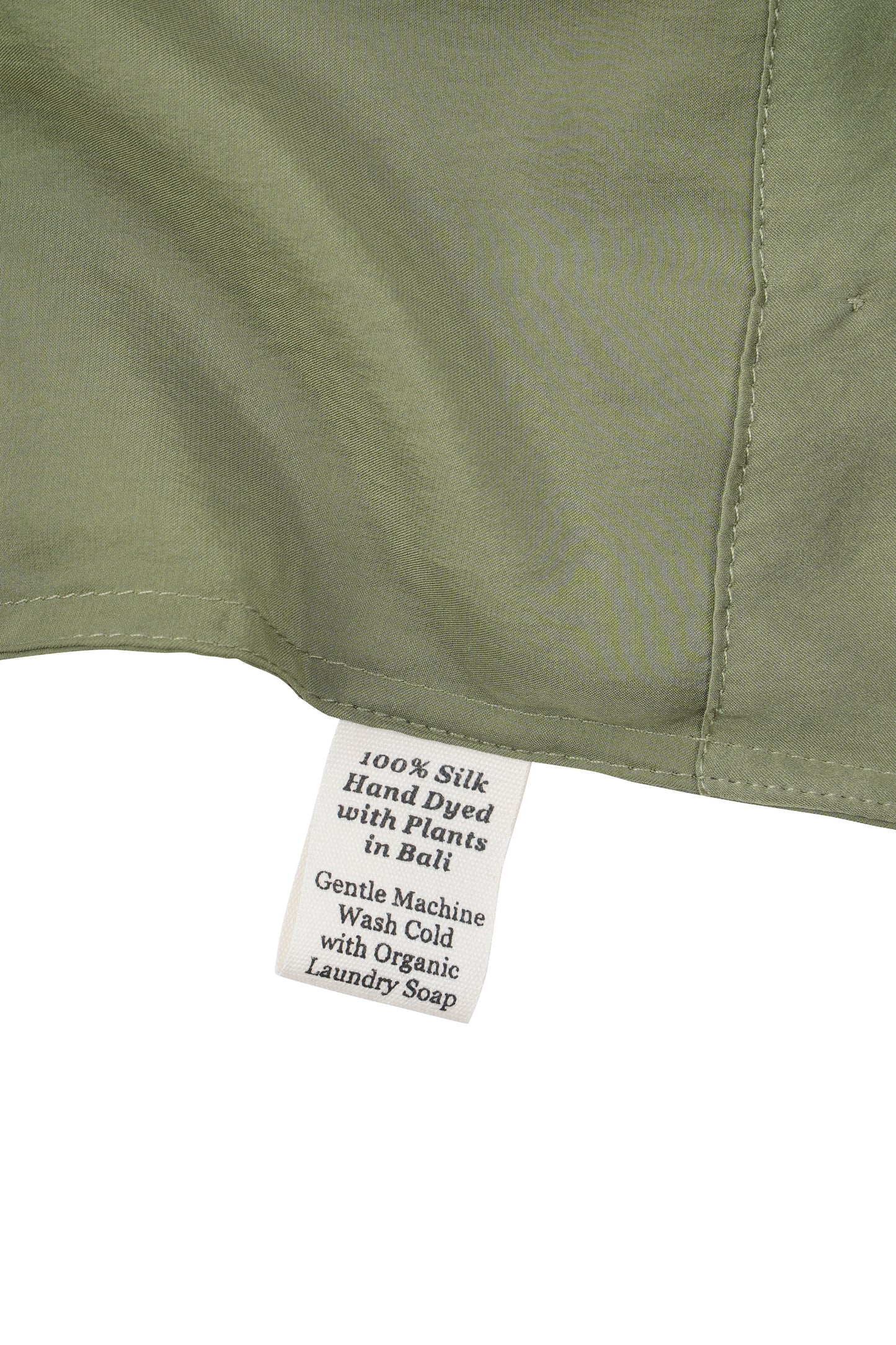 Close-up of a silk in Bark with a label detailing care instructions