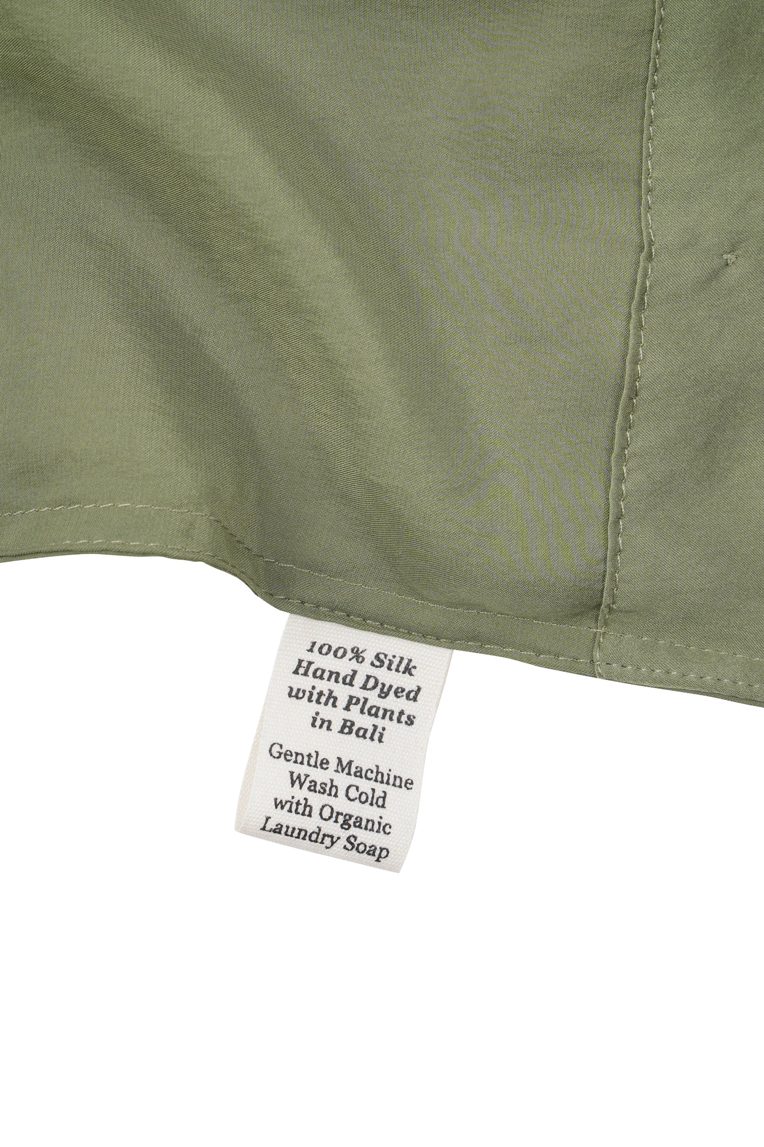 Close-up of a silk in Bark with a label detailing care instructions