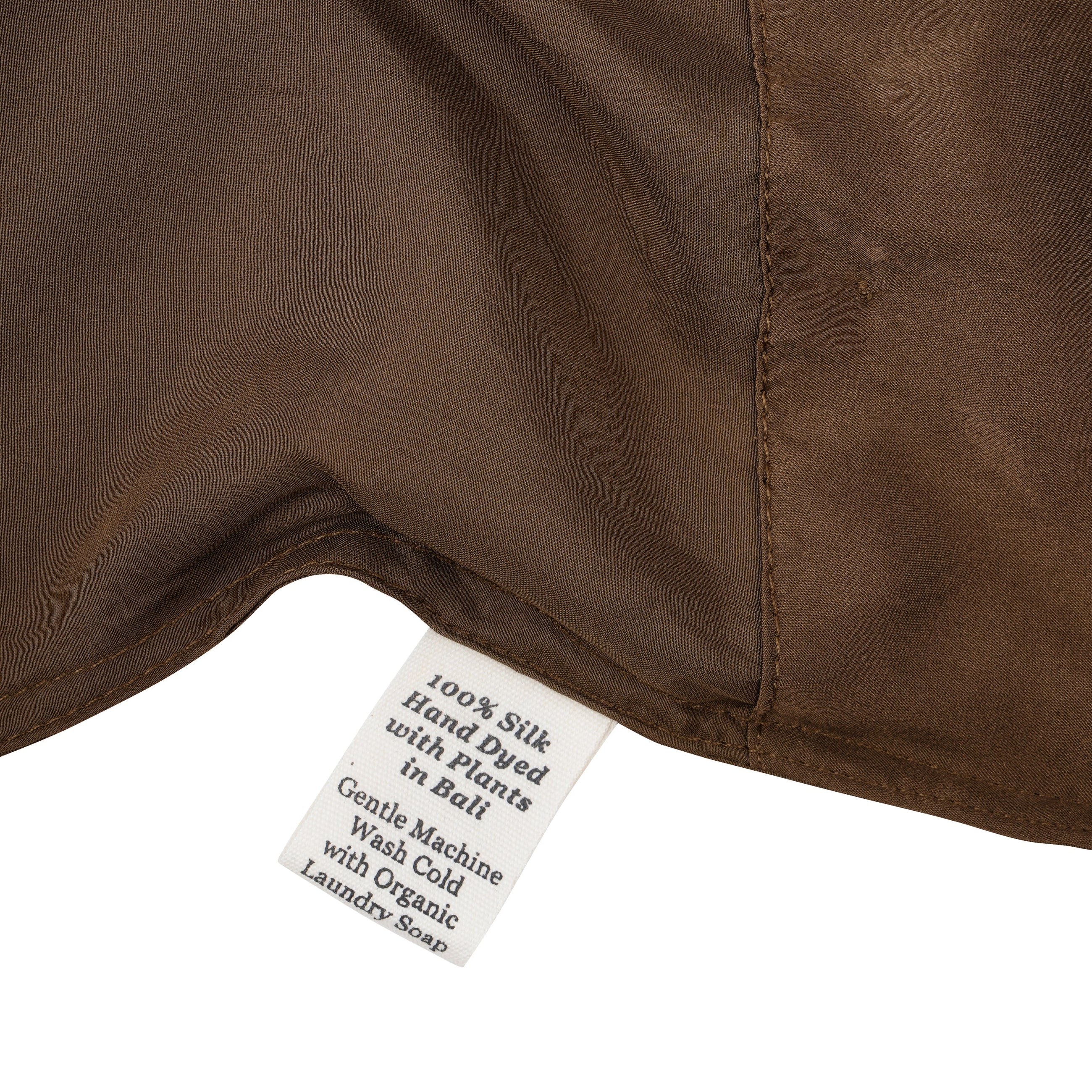 Close-up of a silk in Chaga with a label detailing care instructions