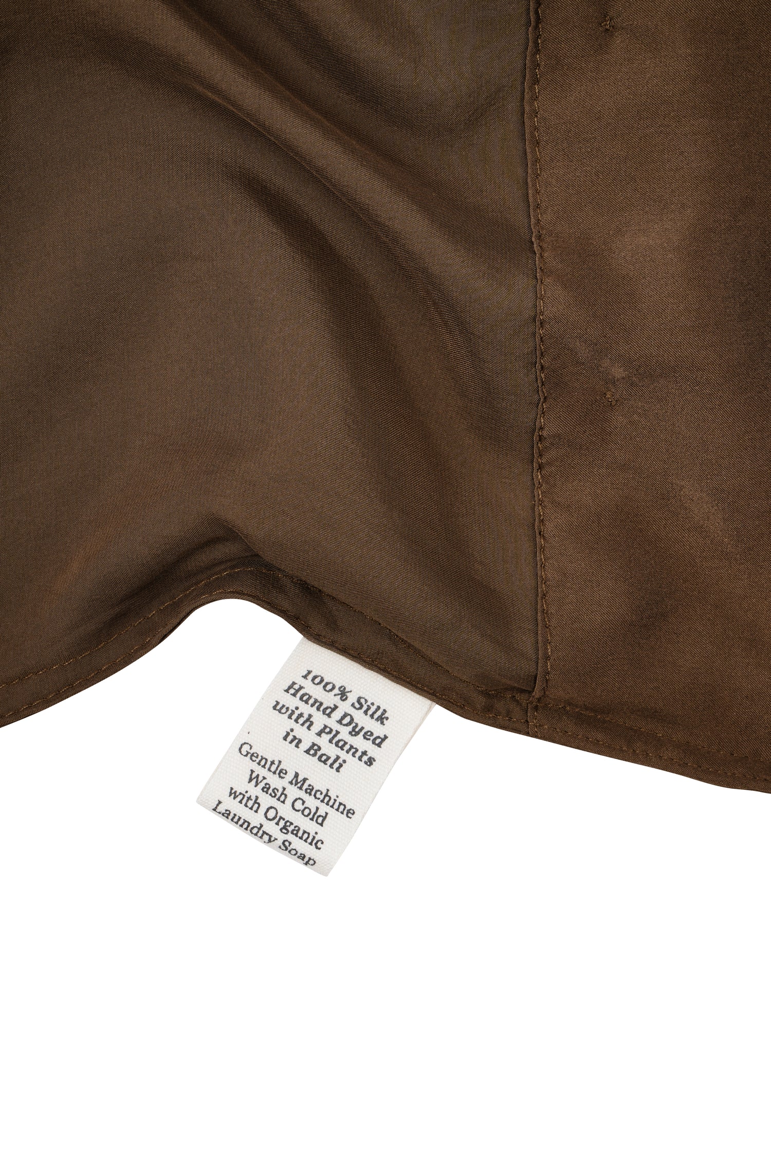 Close-up of a silk in Chaga with a label detailing care instructions